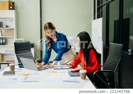 Asian business colleague business presents and explains and using laptop and tablet. Teamwork, financial 121343766