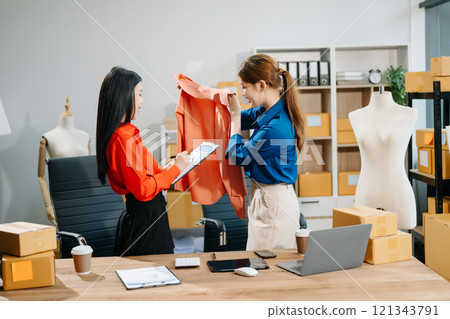 Two professional young Asia cheerful lady fashion designer teamwork with casual site Two professional young Asia cheerful lady fashion designer teamwork with casual site 121343791