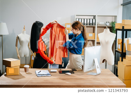 Two professional young Asia cheerful lady fashion designer teamwork with casual site Two professional young Asia cheerful lady fashion designer teamwork with casual site 121343793