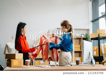 Two professional young Asia cheerful lady fashion designer teamwork with casual site Two professional young Asia cheerful lady fashion designer teamwork with casual site 121343794