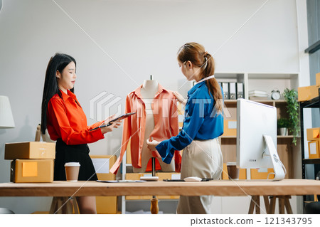 Two professional young Asia cheerful lady fashion designer teamwork with casual site Two professional young Asia cheerful lady fashion designer teamwork with casual site 121343795