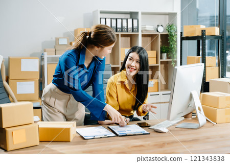 Small business entrepreneur SME freelance Asian woman and woman working at home office 121343838
