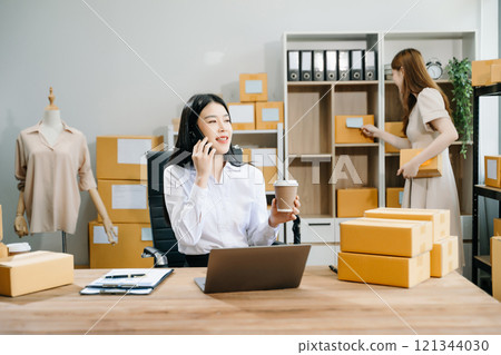 Small business entrepreneur SME freelance Asian woman and woman working at home office 121344030