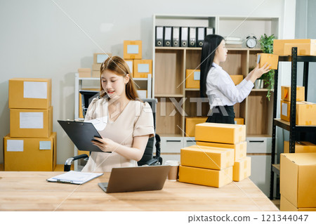 Starting small businesses SME owners, two check online orders Selling products working with boxs freelance work 121344047