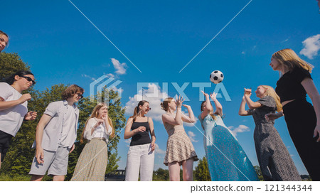 Teenage high school students having fun playing soccer outside on a sunny summer day 121344344