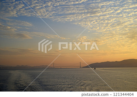 View of the Akashi Kaikyo Bridge in the morning glow from the ferry observation deck -6 121344404