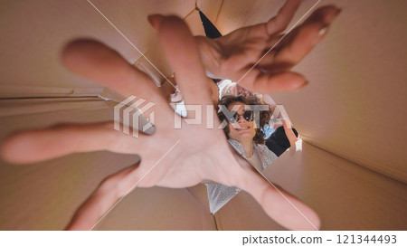 High school students having fun and exploring from inside a cardboard box during their summer break 121344493