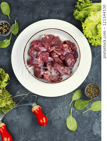 Uncooked raw deer meat fillets. 121344530