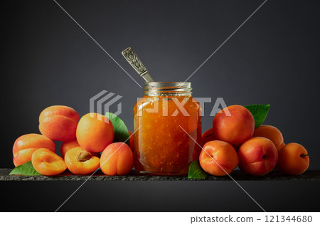 Apricot jam in glass jar and fresh fruits. Apricot jam in glass jar and fresh fruits. 121344680
