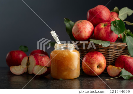 Apple jam and fresh apples on a black stone table. Apple jam and fresh apples on a black stone table. 121344699