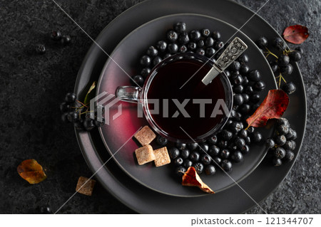 Black chokeberry juice, fresh berries, and pieces of brown sugar. Black chokeberry juice, fresh berries, and pieces of brown sugar. 121344707