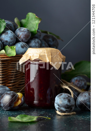 Ripe plums with jam on the kitchen table. 121344708