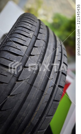 detailed image of a brand new car tire showcasing its intricate tread pattern for enhanced grip and performance 121345436