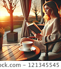 Woman sitting at a table in the park reading a book 121345545