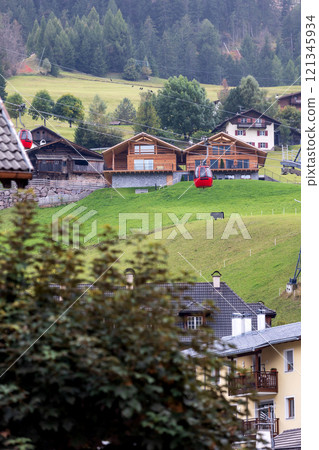 Ortisei, Italy street, Mont Seuc cable car cabins Ortisei, Italy street, Mont Seuc cable car cabins 121345934