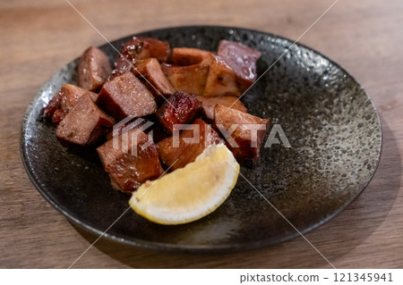 Grilled beef tongue served on plate with lemon Grilled beef tongue served on plate with lemon 121345941