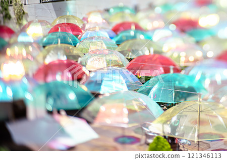 Photographing colorful umbrellas hanging in a shopping center in Kusatsu City, Shiga Prefecture 121346113