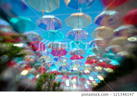 Photographing colorful umbrellas hanging in a shopping center in Kusatsu City, Shiga Prefecture 121346147