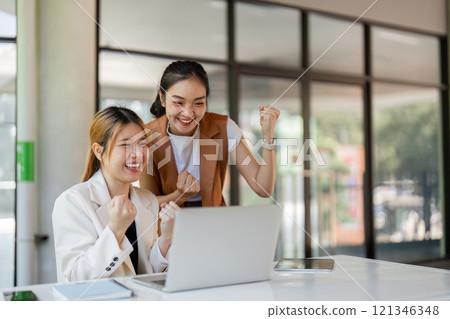 Successful Businessmen Celebrating Achievement with Joyful Expressions in a Modern Office Setting Successful Businessmen Celebrating Achievement with Joyful Expressions in a Modern Office Setting 121346348