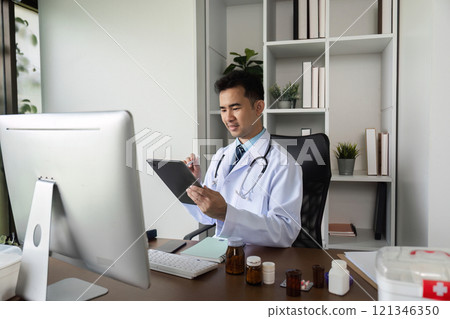 Male Doctor Recommends Medicine for Disease Treatment in Modern Medical Office Setting 121346350
