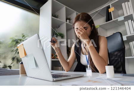 Stressed Businesswoman at Office Desk Experiencing Work Fatigue and Overwhelm in Modern Workplace Environment Stressed Businesswoman at Office Desk Experiencing Work Fatigue and Overwhelm in Modern Workplace Environment 121346404