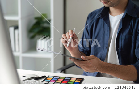 Creative Graphic Designer Selecting Colors for Innovative Digital Design Projects 121346513