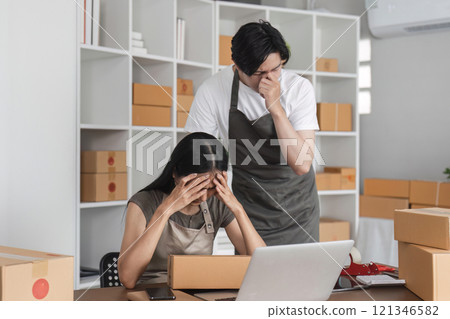 Stressed Couple Analyzing Stock Market Data Online at Home Office with Laptop and Boxes 121346582