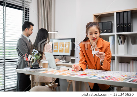 Creative Team of Graphic Designers Collaborating in Modern Office to Develop Innovative Visual Graphics and Digital Artworks 121346620