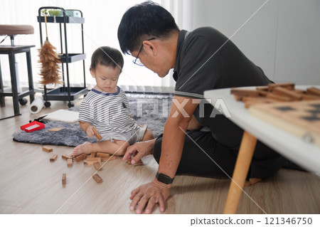 Father and Son Spending Quality Time Together at Home, Building Blocks and Bonding in a Modern Living Room Setting 121346750