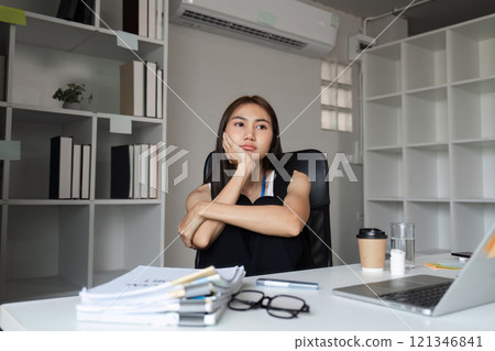 Bored Woman at Work Sitting at Desk in Modern Office with Laptop and Documents, Feeling Uninspired and Unmotivated During Work Hours Bored Woman at Work Sitting at Desk in Modern Office with Laptop and Documents, Feeling Uninspired and Unmotivated During Work Hours 121346841