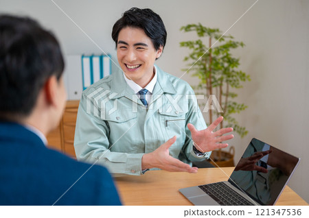 A businessman giving an explanation on a PC A businessman giving an explanation on a PC 121347536