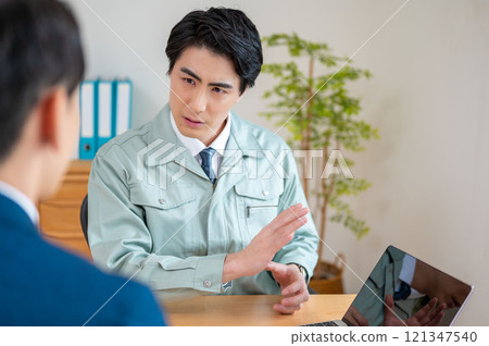 A businessman giving an explanation on a PC A businessman giving an explanation on a PC 121347540