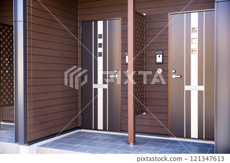 Entrance door of rental apartment building 121347613