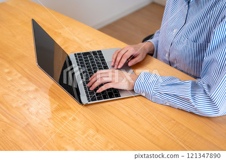 Hands of a woman working on a PC Hands of a woman working on a PC 121347890