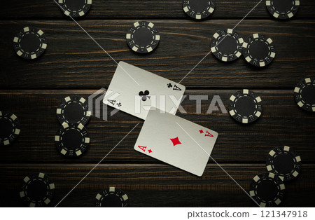 Try to win poker with a good combination of one pair. Chips and cards on a black vintage table in a poker club or casino 121347918