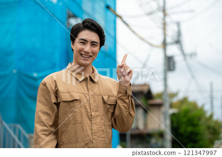 Male worker pointing at a construction site Male worker pointing at a construction site 121347997