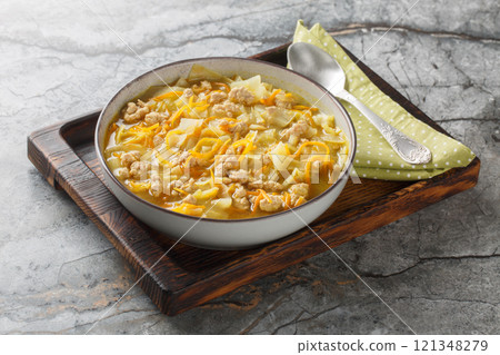 Asian rich egg roll soup with minced meat, cabbage, carrot, onion and spices close-up in a bowl. Horizontal 121348279