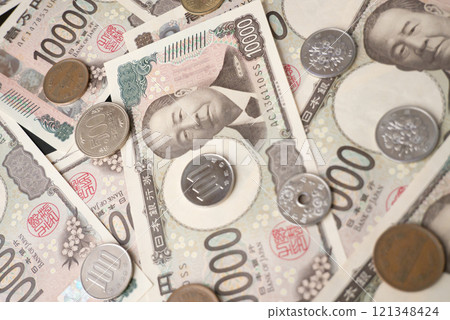 Stock photo of bills and money scattered around 121348424