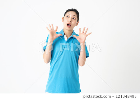 A woman surprised with her arms outstretched 121348493