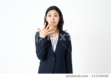 A surprised young woman in a suit 121348498