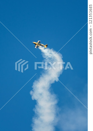 Stunt aerobatic plane performing stunts in air Stunt aerobatic plane performing stunts in air 121351685
