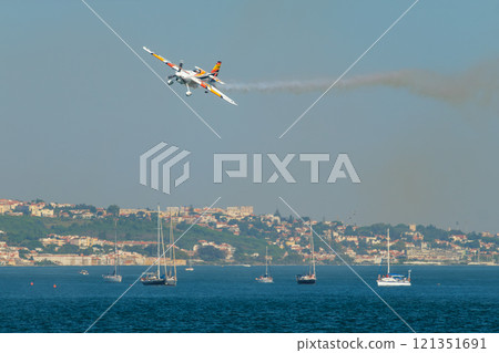 Stunt aerobatic plane performing stunts in air 121351691