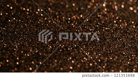 Bokeh powder. Golden glitter. Fading shimmering festive surface with fine metallic dust. Color precious shining glamour blur particles. Bokeh powder. Golden glitter. Fading shimmering festive surface with fine metallic dust. Color precious shining glamour blur particles. 121351698
