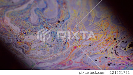Colorful ink. Psychedelic abstraction. Defocused purple green liquid oil paint curve acrylic slick on dark black blurred light art background. 121351751
