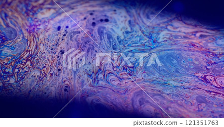 Psychedelic fantasy. Dye mixing. Defocused multicolor purple green liquid paint curve acrylic slick on dark black blurred light abstract art background. 121351763