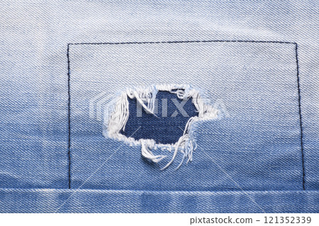 Closeup detail of torn on blue jeans. Denim jeans texture. 121352339