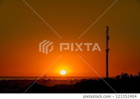 Beautiful sunset on the beach of Los Canos de Meca with the background of the Trafalgar Lighthouse, Barbate, Cadiz 121352404