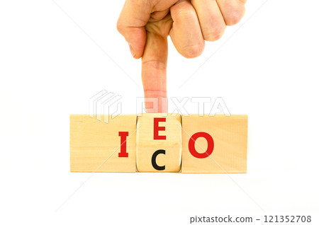 Initial coin or exchange offering symbol. Concept words abbreviation ICO or IEO on wooden block. Beautiful white table white background. Business Initial coin or exchange offering concept. Copy space. 121352708