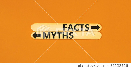 Facts or myths symbol. Concept word Myths and Facts on beautiful wooden stick. Beautiful orange table orange background. Business and facts or myths fact myth concept. Copy space. Facts or myths symbol. Concept word Myths and Facts on beautiful wooden stick. Beautiful orange table orange background. Business and facts or myths fact myth concept. Copy space. 121352726