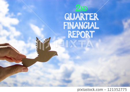 2nd quarter financial report symbol. Concept words 2nd quarter financial report. Beautiful blue sky and clouds background. Businessman hand. Business 2nd quarter financial report concept. Copy space. 2nd quarter financial report symbol. Concept words 2nd quarter financial report. Beautiful blue sky and clouds background. Businessman hand. Business 2nd quarter financial report concept. Copy space. 121352775